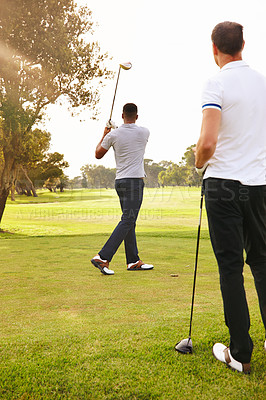 Buy stock photo Man, friends and swing with club on golf course for sports game, outdoor match or competition on green grass. Rear view of male person, golfer or people hitting ball for exercise or practice on field