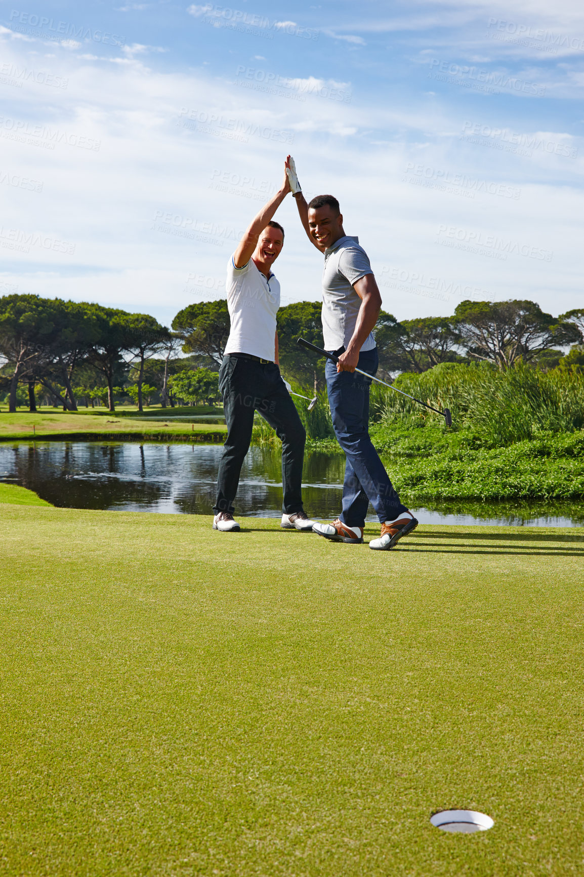 Buy stock photo Happy man, high five and celebration with hole on golf course for winning, point or score in nature. Male person, friends or people touching with smile for teamwork, victory or match on grass field