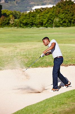 Buy stock photo Man, swing and club on golf course in sand pit for par, bogey or stroke with grass field in nature. Young male person, golfer or sports player hitting ball out for strike, point or tough outdoor shot