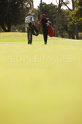 Buy stock photo Walking, people and men together on golf course with golfing bag for training, health and teamwork. Male friends, sports equipment and exercise for activity with sportswear, lawn and trees outdoor