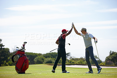 Buy stock photo Shot of two happy men playing a game of golf