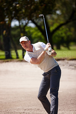 Buy stock photo Man, golfer and hit with club on golf course in sand pit for stroke, point or strike by grass field in nature. Male person or sports player with swing on ball in dirt for par, game or outdoor match