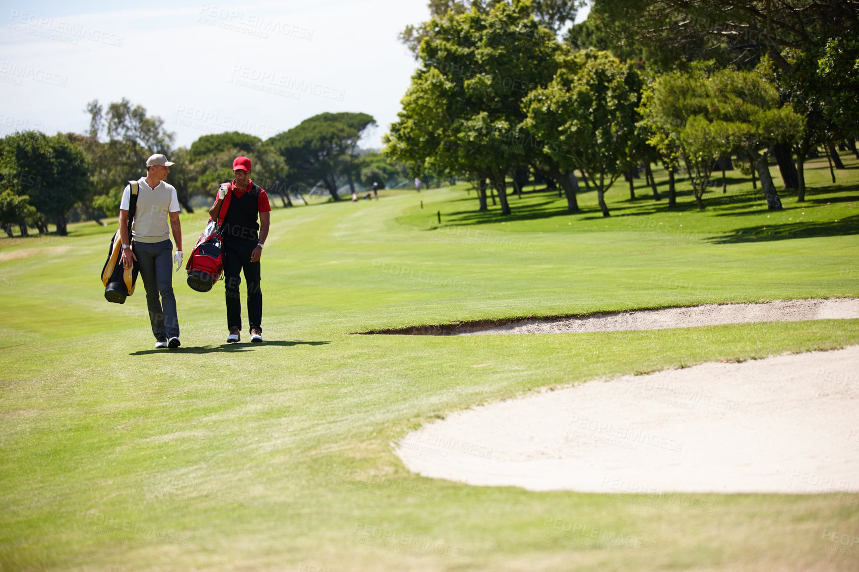 Buy stock photo Golf, sports and men walking with bag after practice or training on green lawn for partnership or collaboration. Friends, golfers and exercise for trust, fitness and community outdoor on field.