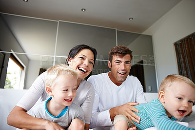 Buy stock photo Parents, children and smile in house for childhood, development and happiness on sofa for fun indoor. Mother, father and boy or kid in living room for sibling, play and bonding with family on weekend