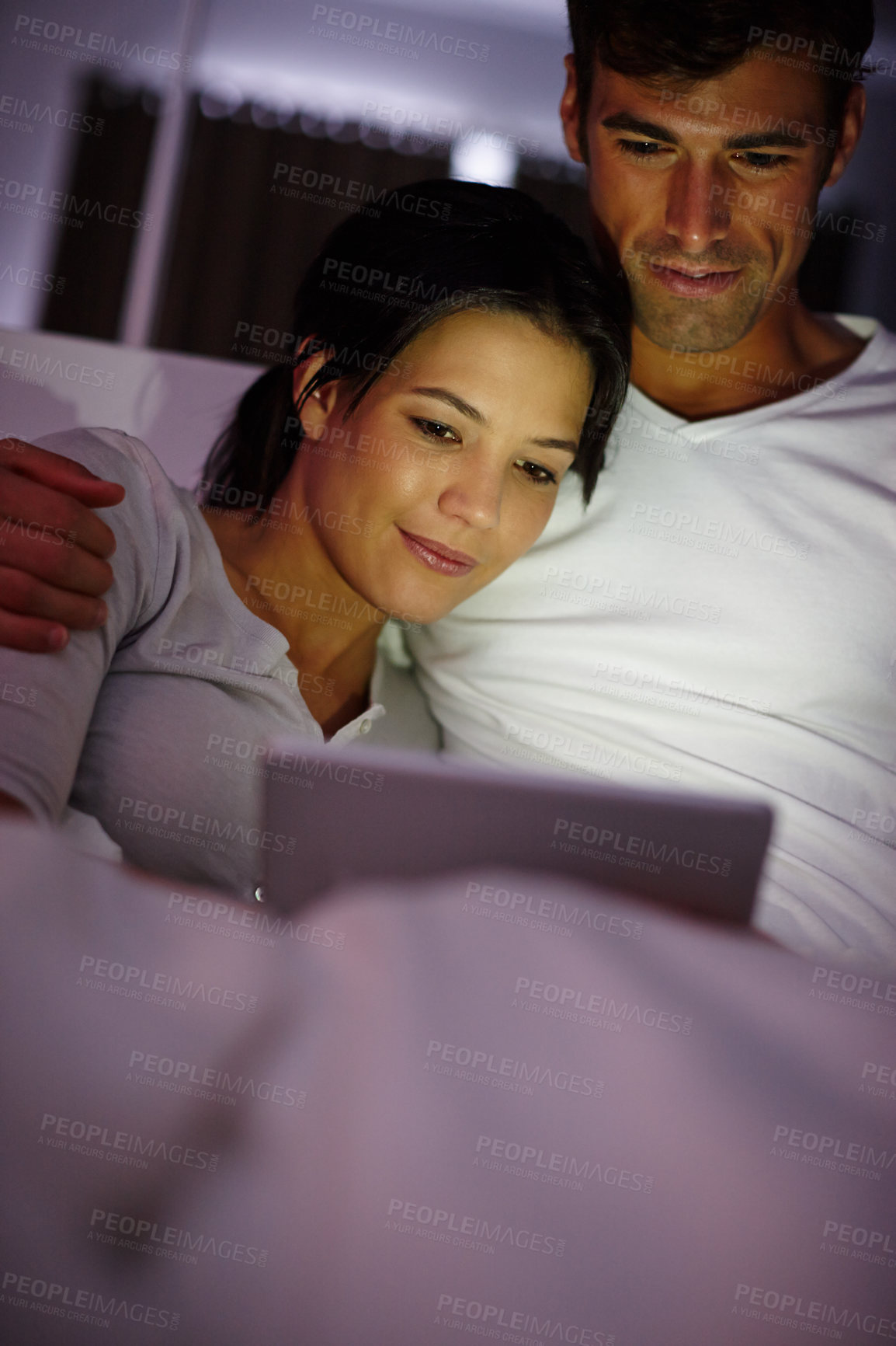 Buy stock photo Couple, tablet and bedroom for streaming, love and relax in house with digital, technology and internet at night. Man, tech and woman in bed in home with smile for movie, entertainment and video