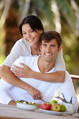 Buy stock photo Portrait of a loving couple having breakfast together outdoors