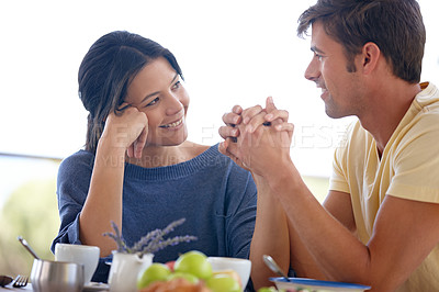 Buy stock photo Cropped shot of a loving couple sitting outdoors on a sunny morning 