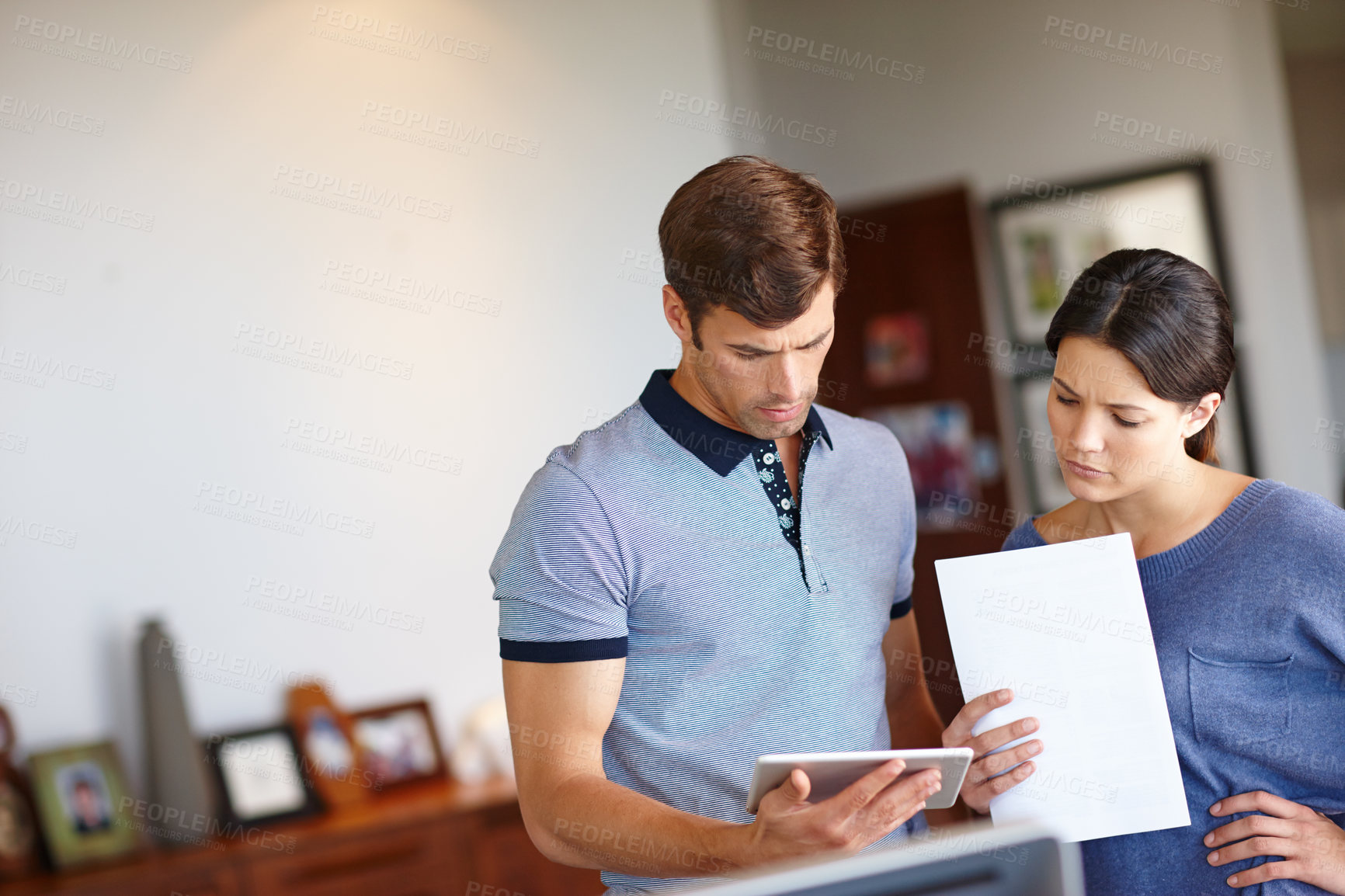 Buy stock photo Man, woman and tablet with paper for documents, paperwork and thinking for for remote work in startup business. People, teamwork and partnership in house, living room and home with technology