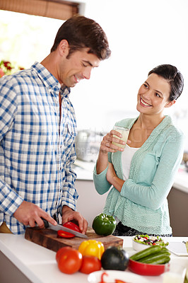 Buy stock photo Cropped shot of a couple preparing a meal together at home 