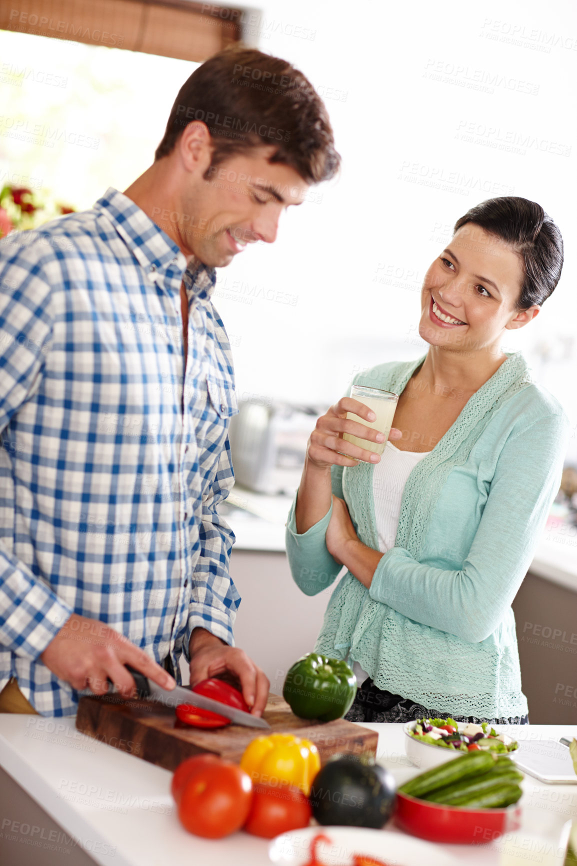 Buy stock photo Cropped shot of a couple preparing a meal together at home 