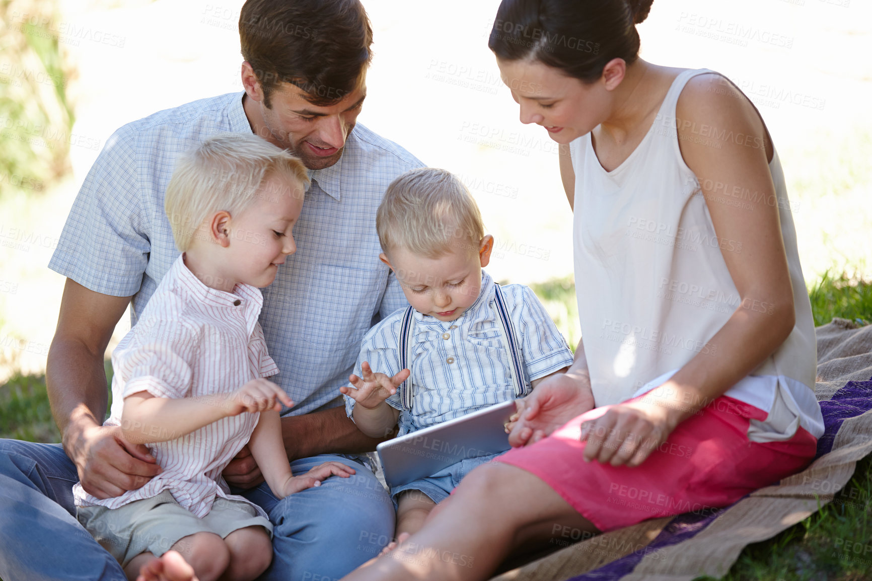 Buy stock photo Cropped shot of a happy family spending time together outdoors 