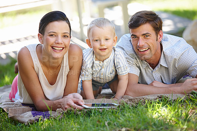 Buy stock photo Parents, child and happy with tablet, portrait and garden for e learning, development and growth. Man, woman and boy on technology, smiling and educational gaming for motor skills, bonding and family