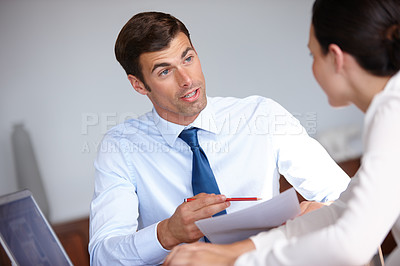 Buy stock photo Cropped shot of two business colleagues working together in an office
