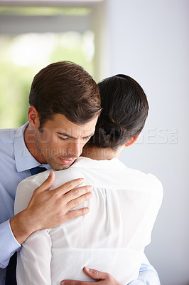 Buy stock photo Businessman hug woman for comfort, support and relief at company office. Sad employee and manager help with grief, anxiety and work stress for depression or mental health at professional workplace