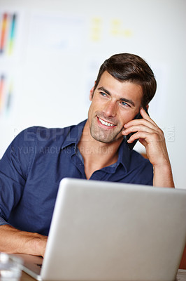 Buy stock photo Cropped shot of a businessman talking on the phone while working on his laptop 