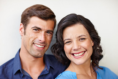Buy stock photo Portrait of a beautiful couple smiling happily while spending time together