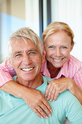 Buy stock photo Happy and mature couple in portrait with hug, romance and support for anniversary in house. Senior, man and woman with smile for marriage, relationship and trust on retirement or vacation at home