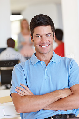 Buy stock photo Portrait of a casual businessman with his colleagues working in the background