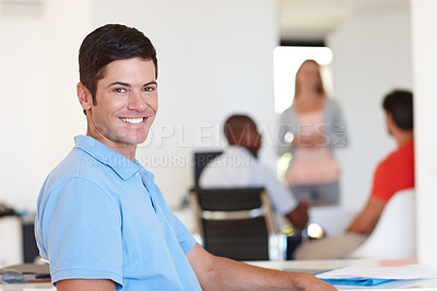 Buy stock photo Casual, male person and smile in portrait at office with colleagues, working or job or happy. Businessman, company and confidence with coworkers at desk for events management, planner or coordinator