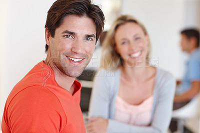 Buy stock photo Portrait of a casual businessman working with a female colleague