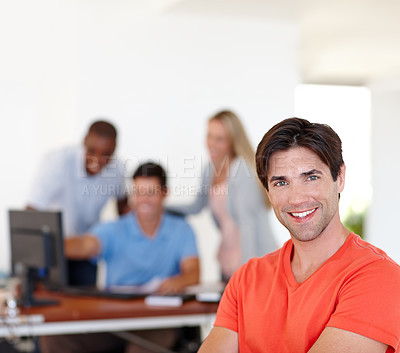 Buy stock photo Casual, businessman and happy in portrait at job with colleagues, working or office or smile. Male person, company and confidence with coworkers at desk for events management, planner or coordinator