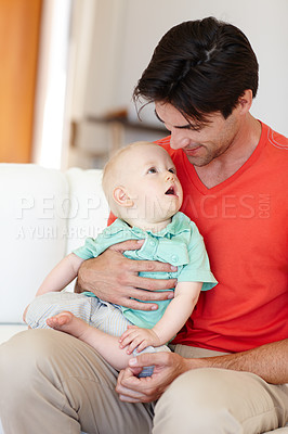 Buy stock photo Father, toddler and hug while talking on couch, love and bonding for child development in home. Daddy, boy and embrace in conversation or single parent, comfort and security in connection on sofa