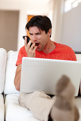 Buy stock photo Man, angry and phone call in living room with laptop for business, entertainment or work from home. Person, notebook and mobile upset for communication, deal or conversation with network provider