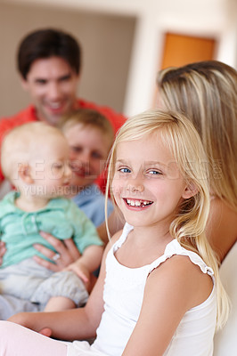 Buy stock photo Portrait, young girl and parent with siblings at family house by embrace, bonding and love on couch. People, mom and dad with children on vacation together on sofa at childhood home for memory
