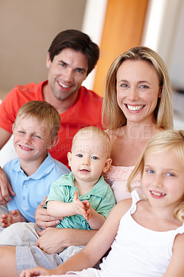 Buy stock photo Portrait of a cute little girl sitting on the sofa with her whole family
