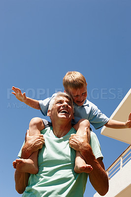 Buy stock photo Kid, happy and on grandpa shoulder for bonding, family game or development at home flying. Parent, smiling and grandchild excited sitting on senior for summer entertainment, amusement or retirement