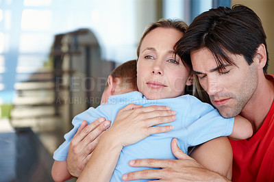 Buy stock photo Parents, boy and hug in embrace for support, development and growth with eyes closed at home. Woman, man and young child in comfort, childcare and parenthood in bonding, relationship and family