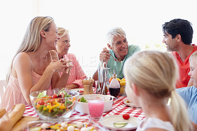 Buy stock photo Happy, family and young girl in living room at table with salad, vegetables and eating together for lunch. Mom, dad and children on vacation at childhood house visiting grandparents for memory