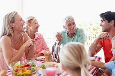 Buy stock photo Shot of a multi-generational family having lunch together at an outdoor table