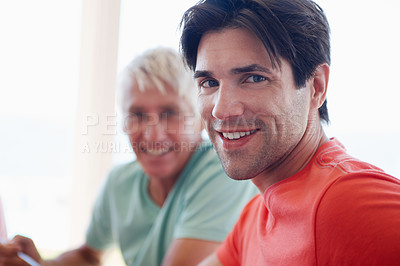 Buy stock photo Portrait, man and senior man in living room with smile, joyful and cheerful at home as family. Male people, happy and relationship for father and son, bonding and support in house for togetherness