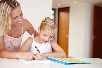 Buy stock photo Mom, happy and child writing on notebook for development, learning or educational training. Woman, girl and book smile doing homework in living room for bonding, studying or tutoring after school