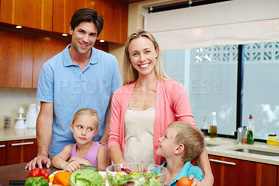 Buy stock photo Happy family, healthy food and kitchen counter at home with smile for dinner, love and connection or togetherness. Male, female person and children at house and cooking with salad, diet or nutrition
