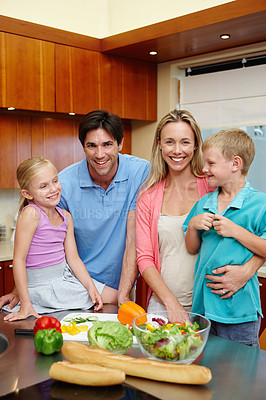 Buy stock photo Happy family, healthy food and kitchen counter at house with smile for dinner, love and connection or togetherness. Male, female person and children at home and cooking with salad, diet or nutrition
