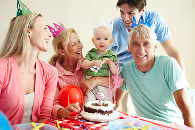Buy stock photo Portrait, big family or cake at happy birthday, party or celebrate as care, love or bonding together. Grandpa, home or baby to smile at paper hat, balloon or colorful memory of child development