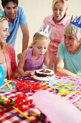 Buy stock photo Shot of a little girl celebrating her birthday with all her family