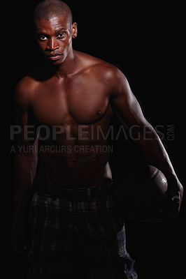 Buy stock photo Portrait of a determined young basketball player standing against a black background