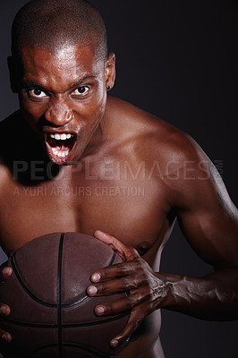 Buy stock photo Studio portrait of a determined young basketball player standing against a black background
