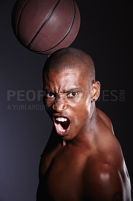 Buy stock photo Studio portrait of a determined young basketball player standing against a black background