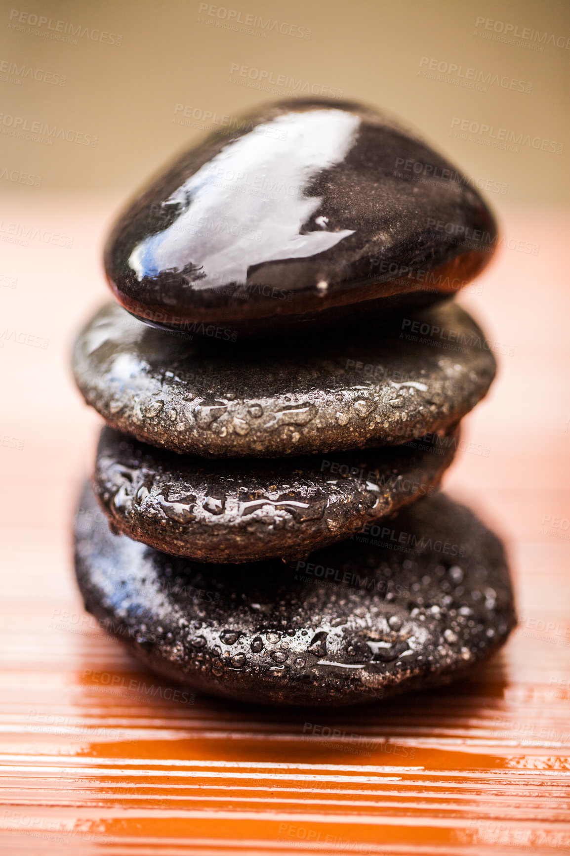 Buy stock photo Stones, zen and wet rocks for hot stone massage at a spa for luxury and wellness. Peace, closeup and rock balance with tranquility and feng shui for meditation, holistic therapy and water on pile