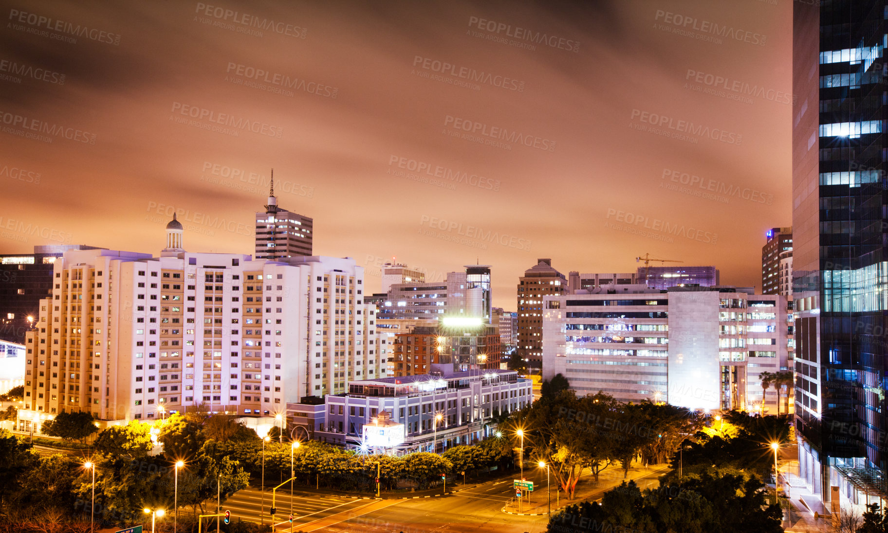 Buy stock photo Shot of a city with lights coming on as the sky turns dark