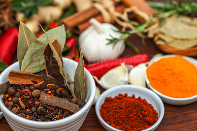 Buy stock photo Food, leaf and spices on table top for cooking meal, turmeric seasoning or paprika flavor. Vegetables, kitchen condiments and variety of plant herbs in bowls for brunch, healthy diet or vitamins.