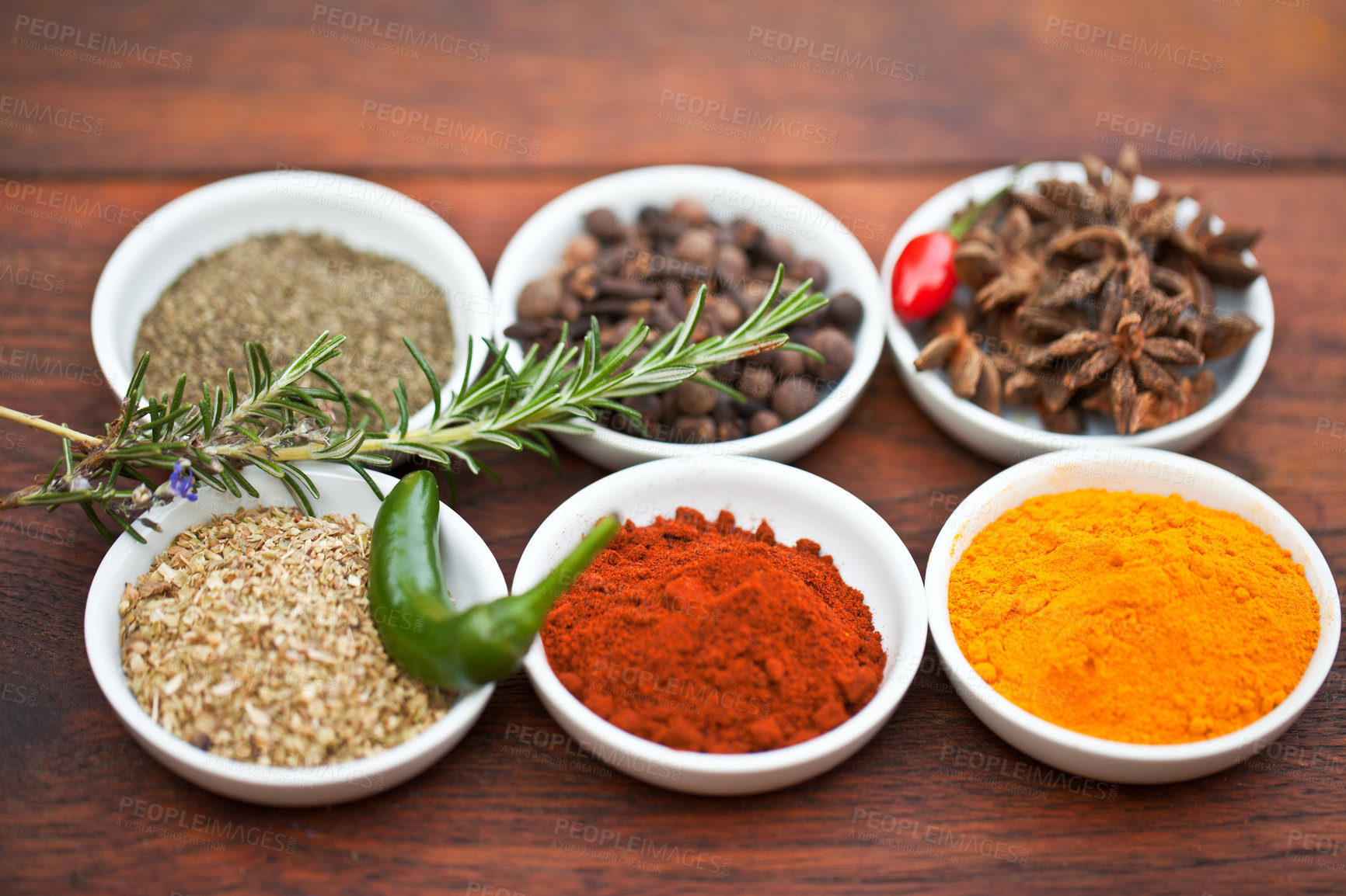 Buy stock photo Food, turmeric and spices on table top for cooking gourmet meal, pepper seasoning or paprika flavor. Vegetables leaf, kitchen condiments and variety of plant herbs in bowls for brunch or healthy diet