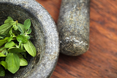 Buy stock photo Plant cooking, mortar and pestle for herbs on table top in kitchen. Vegetables, food and equipment for crushing basil leaf, plants or spices for gourmet meal, seasoning and flavor for healthy diet.