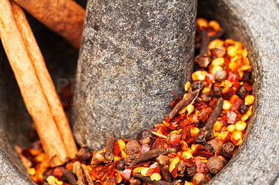 Buy stock photo Closeup, herbs and crush spices for curry on stone mortar or bowl or grind for powder seasoning and on close up. Nutrition, diet and garlic or pestle in coriander or natural salt for taste in food 