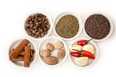 Buy stock photo Shot of an assortment of colorful spices against a white background