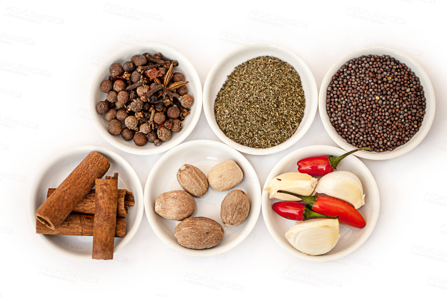 Buy stock photo Shot of an assortment of colorful spices against a white background